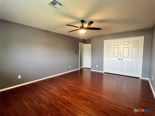 unfurnished bedroom featuring dark hardwood / wood-style flooring and ceiling fan