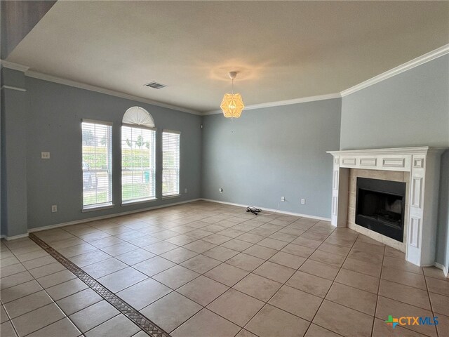 unfurnished living room featuring light tile patterned floors, crown molding, and a tile fireplace