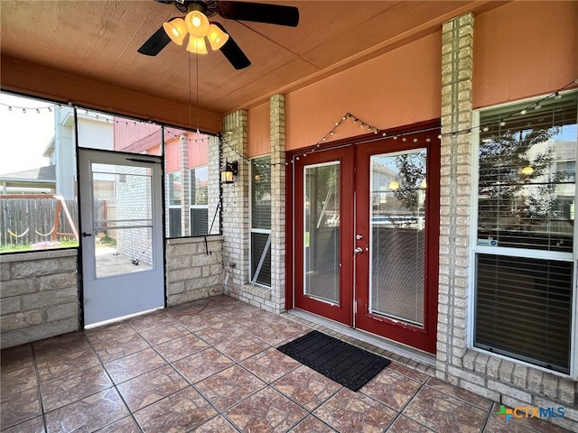 unfurnished sunroom featuring french doors, ceiling fan, and wood ceiling