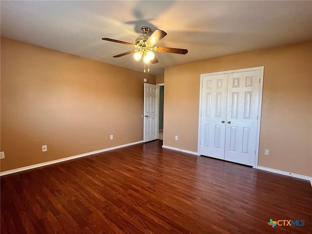 unfurnished bedroom with ceiling fan, a closet, and dark hardwood / wood-style floors