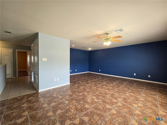 tiled empty room with ceiling fan