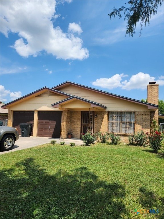 ranch-style home with a garage, brick siding, concrete driveway, and a front lawn