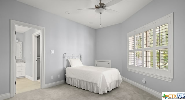 carpeted bedroom with connected bathroom and ceiling fan