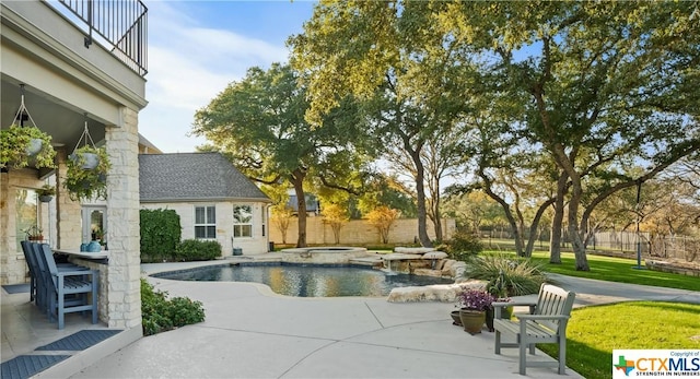 view of swimming pool with an in ground hot tub, an outdoor bar, and a patio area