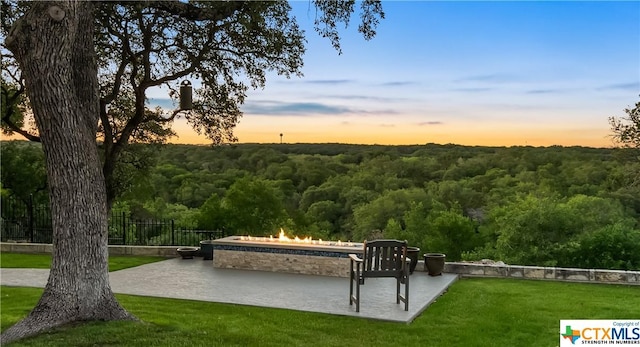 surrounding community featuring a yard, a patio, and an outdoor fire pit