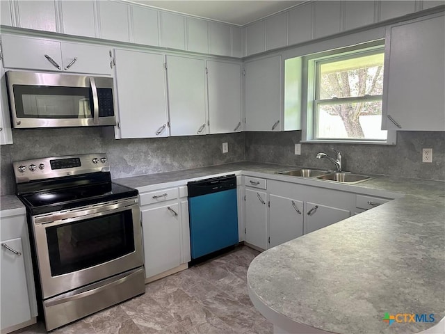 2303 Bon Aire Ave, Victoria, TX 77901 - kitchen featuring appliances with stainless steel finishes, backsplash, light countertops, and white cabinets