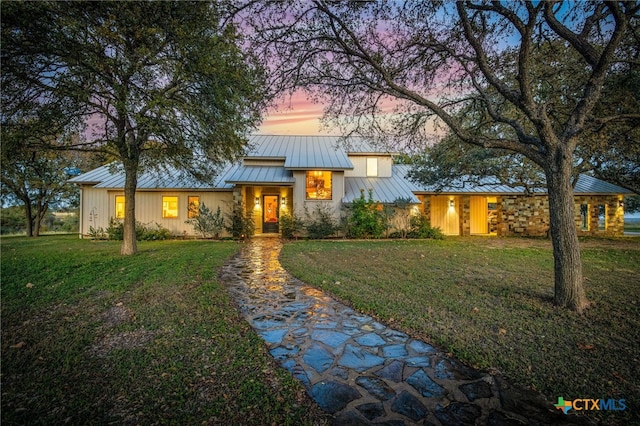 view of front of property with a lawn