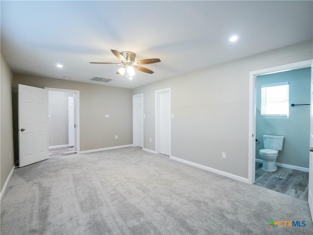 unfurnished bedroom featuring carpet flooring, ensuite bathroom, and ceiling fan