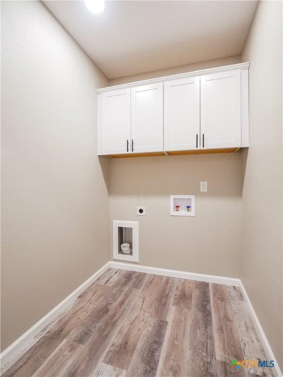 clothes washing area featuring cabinets, hookup for a washing machine, light wood-type flooring, and electric dryer hookup