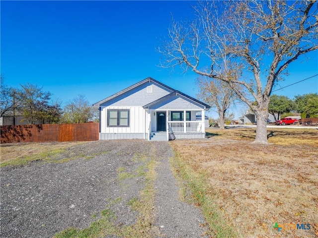 view of front of home with a porch and a front lawn