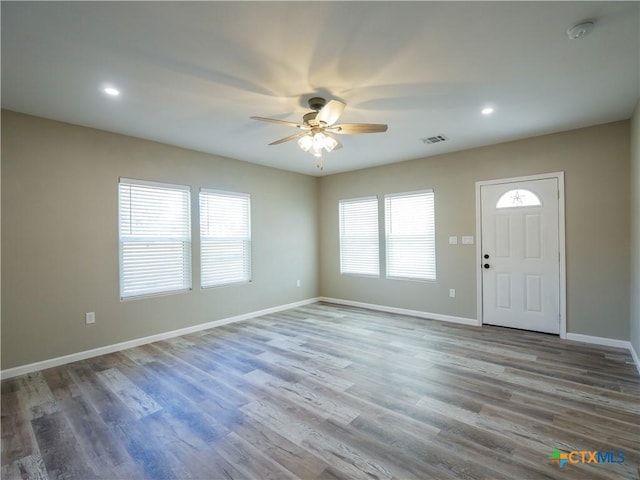 entryway with ceiling fan, a healthy amount of sunlight, and hardwood / wood-style flooring