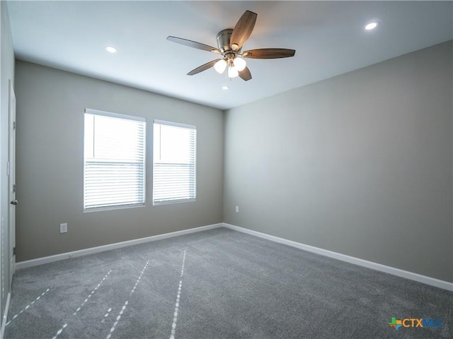 carpeted spare room with ceiling fan