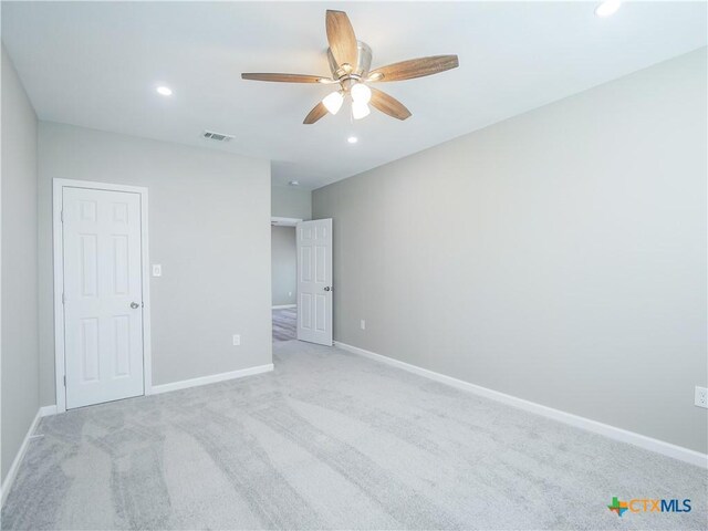 unfurnished bedroom featuring ceiling fan and light colored carpet