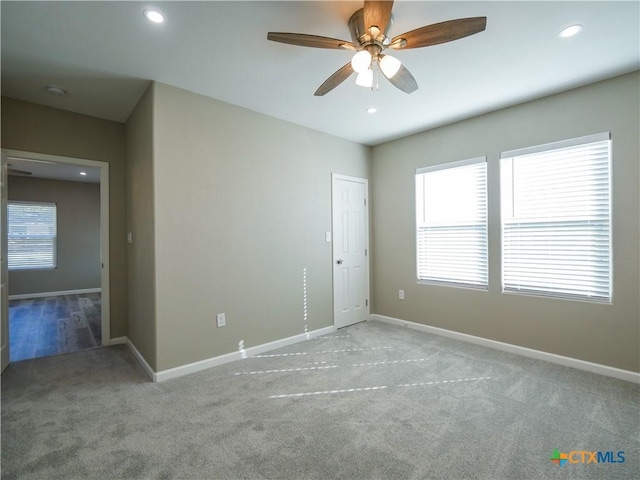 carpeted empty room with ceiling fan