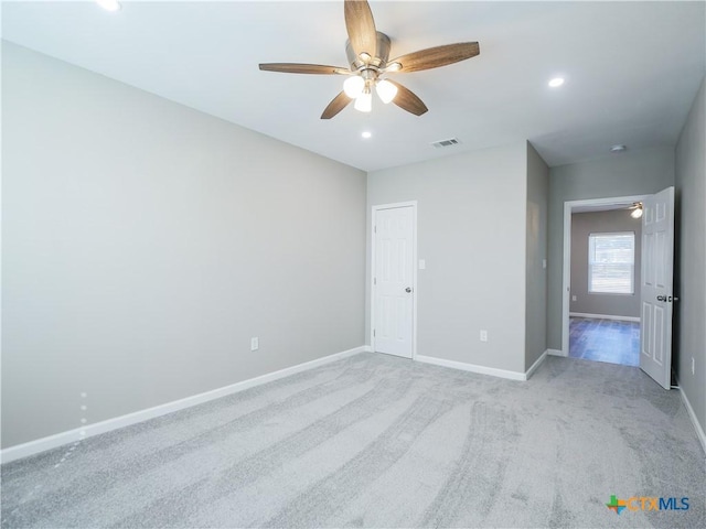 unfurnished bedroom featuring ceiling fan and light carpet