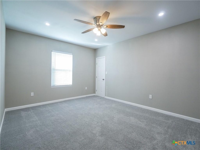 empty room with ceiling fan and carpet