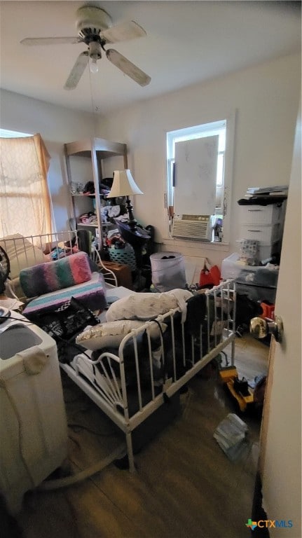 bedroom with cooling unit, wood-type flooring, and ceiling fan