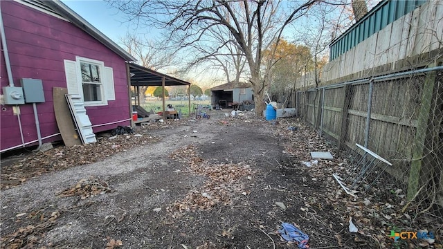 view of yard with an outdoor structure and fence