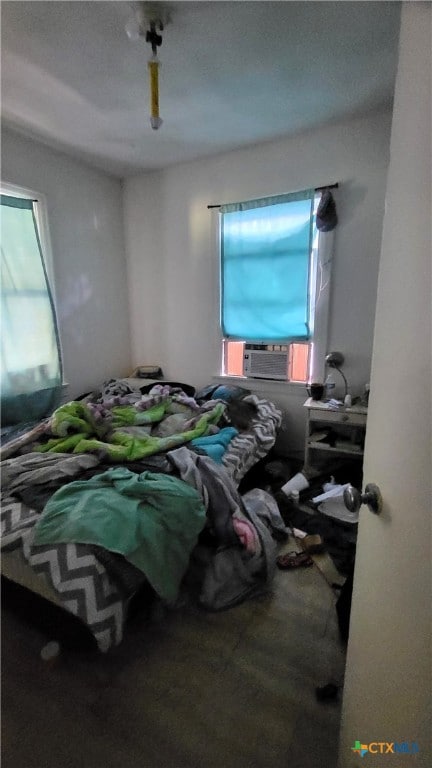 bedroom featuring ceiling fan and cooling unit