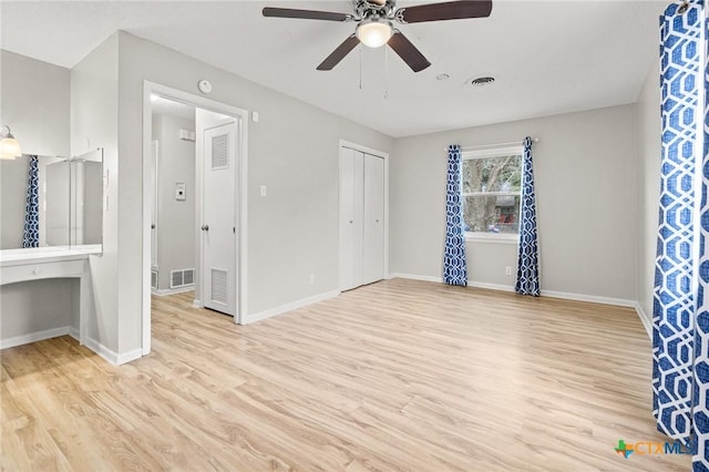 unfurnished bedroom featuring wood finished floors, visible vents, and baseboards