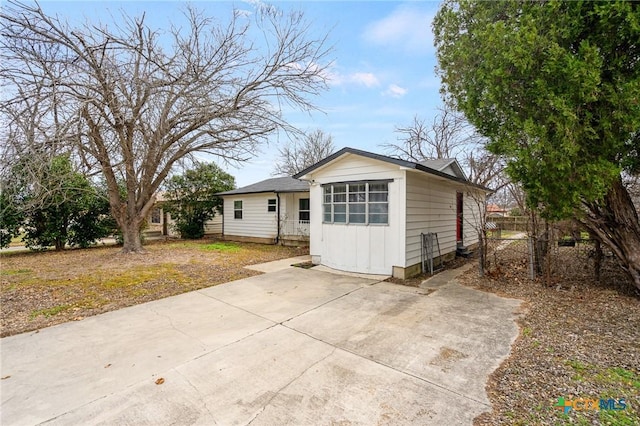 view of front of property featuring board and batten siding and fence