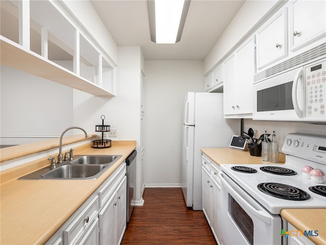 kitchen featuring white appliances, light countertops, a sink, and white cabinetry