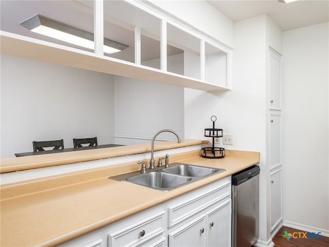 kitchen with dishwasher, light countertops, white cabinetry, open shelves, and a sink