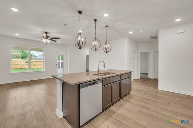 kitchen featuring stainless steel dishwasher, a sink, visible vents, and light wood-style flooring