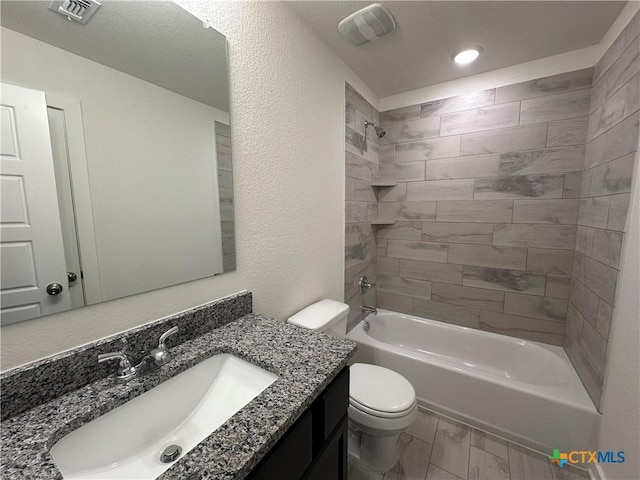 bathroom with visible vents, vanity, toilet, and bathing tub / shower combination