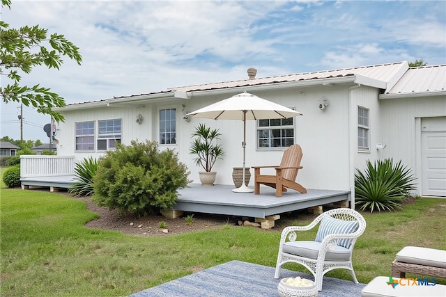 890 N Quail Run Ave, Port Lavaca, TX 77979 - rear view of house with a wooden deck, a yard, and metal roof