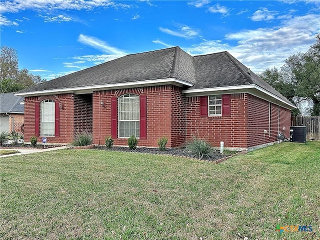 ranch-style home featuring a front yard and central air condition unit