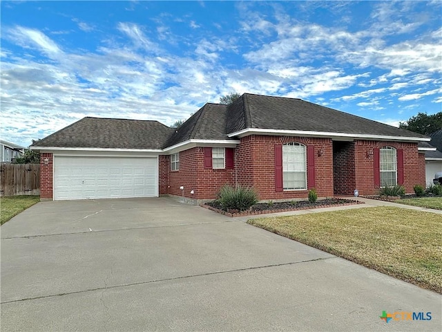 view of front of home featuring a front lawn and a garage