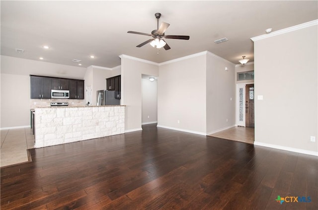 unfurnished living room featuring visible vents, a ceiling fan, baseboards, and hardwood / wood-style flooring