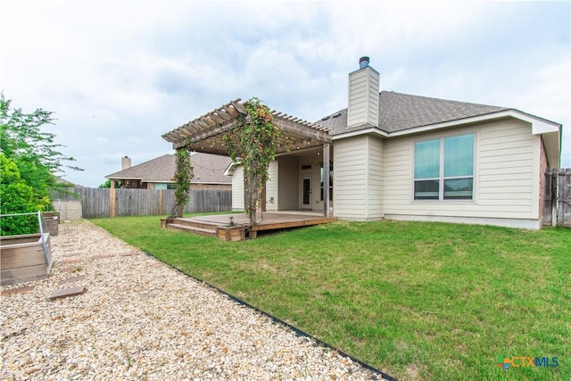 rear view of property featuring a yard, a pergola, a shingled roof, and a fenced backyard