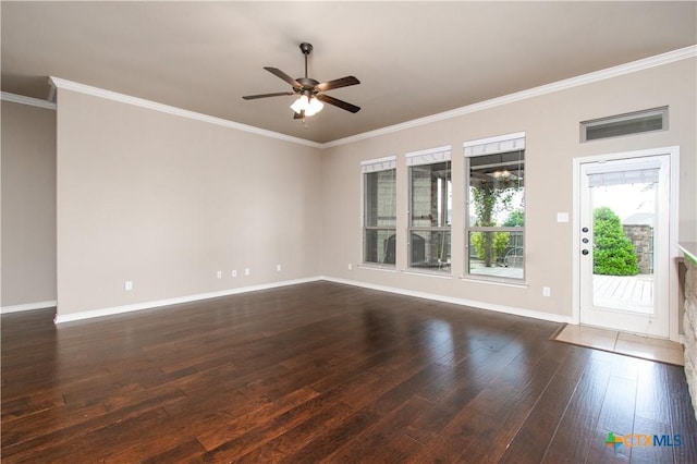 spare room featuring crown molding, a ceiling fan, baseboards, and dark wood finished floors