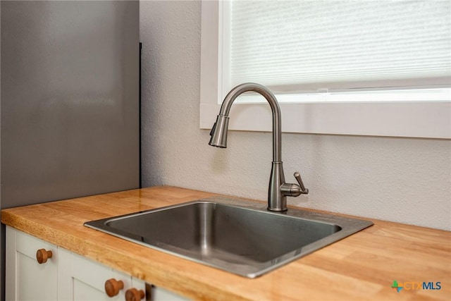 1707 N Ocean Dr, Port Lavaca, TX 77979 - kitchen view of a sink, white cabinetry, and a textured wall
