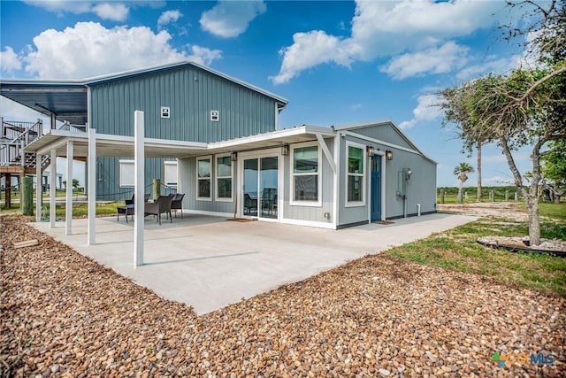 1707 N Ocean Dr, Port Lavaca, TX 77979 - rear view of property with a patio area and board and batten siding