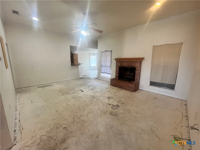 unfurnished living room featuring a brick fireplace, ornamental molding, and ceiling fan