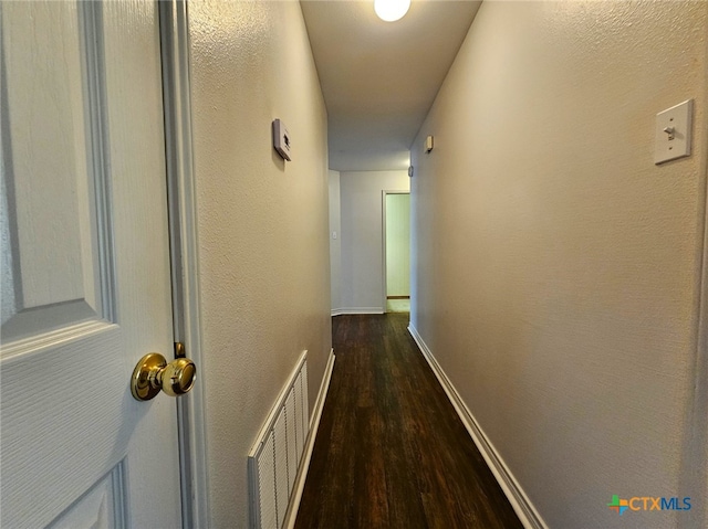 hallway featuring dark wood-type flooring