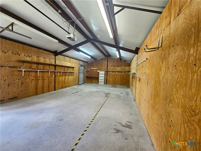 garage featuring wooden walls and a garage door opener