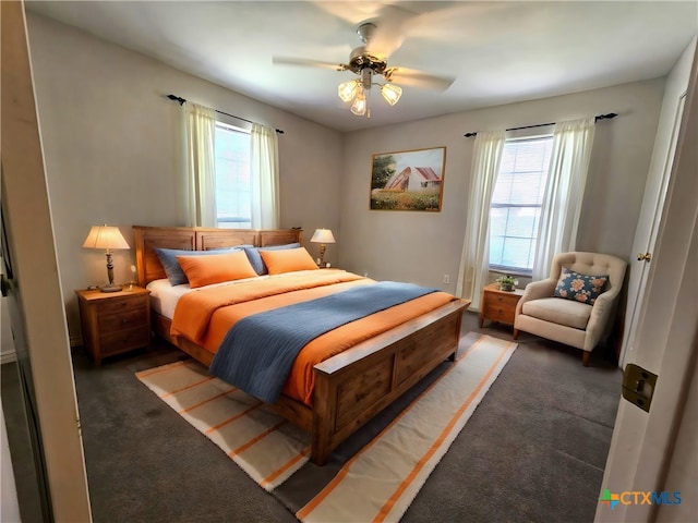 carpeted bedroom with ceiling fan and multiple windows