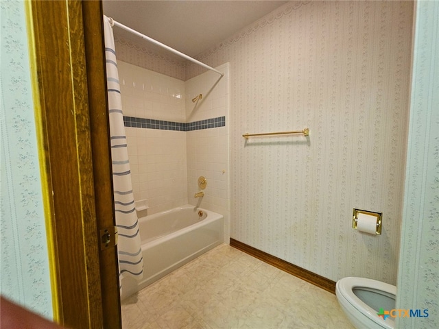 bathroom featuring shower / bath combo and toilet