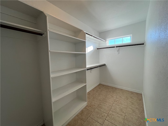 walk in closet featuring light tile patterned flooring