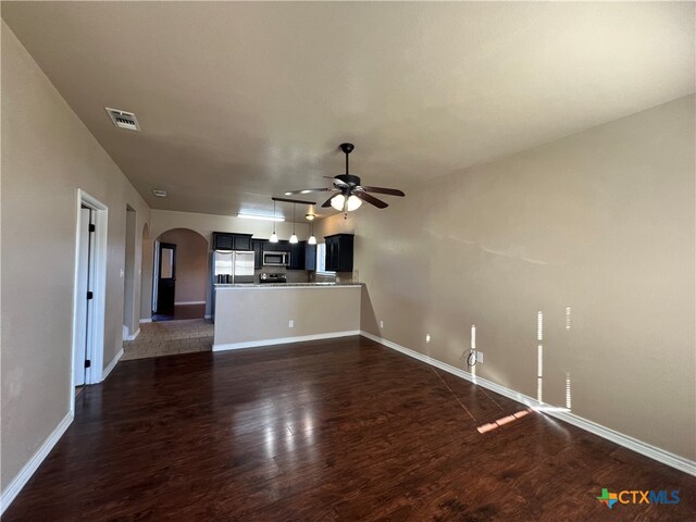 unfurnished living room with dark wood-type flooring and ceiling fan