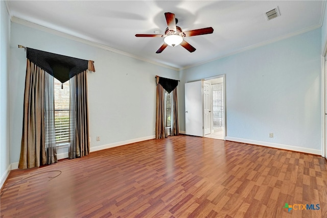 210 Oak Creek Cir, Luling, TX 78648 - spare room featuring wood finished floors, a ceiling fan, and crown molding