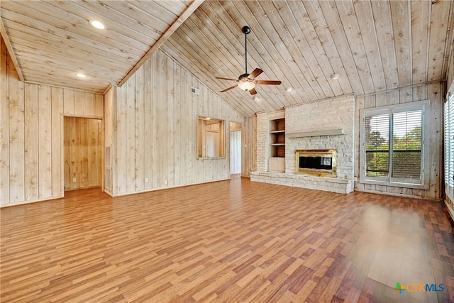 210 Oak Creek Cir, Luling, TX 78648 - unfurnished living room with built in shelves, wood ceiling, wood finished floors, vaulted ceiling, and wood walls