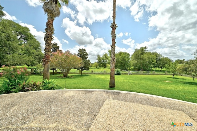 210 Oak Creek Cir, Luling, TX 78648 - view of community featuring a lawn and view of wooded area