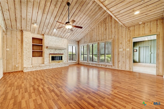 210 Oak Creek Cir, Luling, TX 78648 - unfurnished living room featuring wooden ceiling, built in features, wood finished floors, wood walls, and ceiling fan