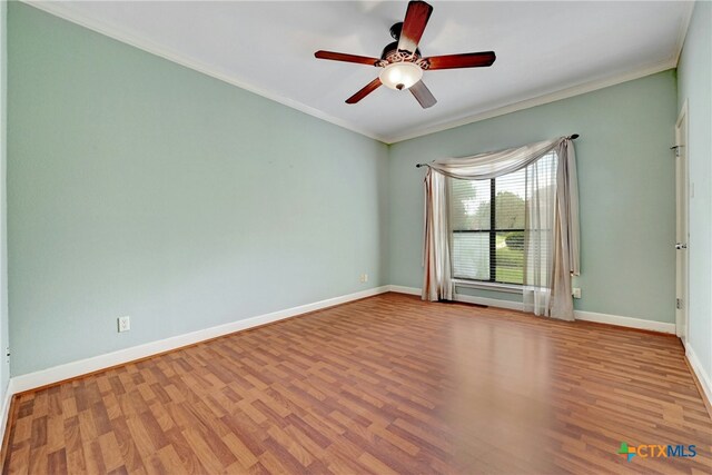 210 Oak Creek Cir, Luling, TX 78648 - empty room featuring wood finished floors, crown molding, and ceiling fan