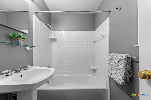 3610 Sierra Blanca Blvd, Temple, TX 76502 - bathroom with a textured wall,  shower combination, and a sink